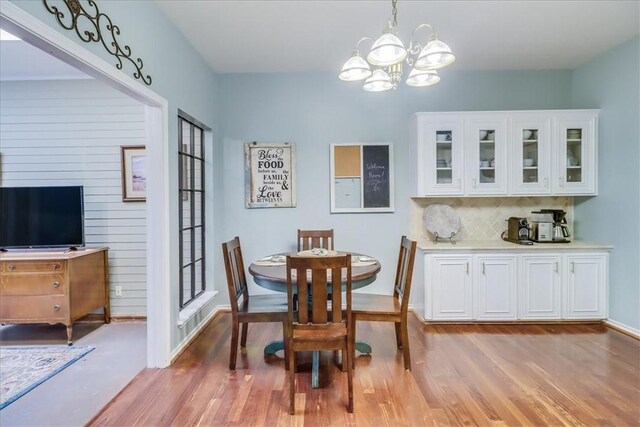 7430 Bourget Dr, Corpus Christi, TX 78413 - dining space with a chandelier and light wood-style floors