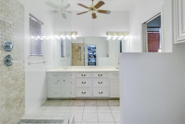7430 Bourget Dr, Corpus Christi, TX 78413 - bathroom featuring tiled shower, ceiling fan, tile patterned flooring, double vanity, and a towering ceiling