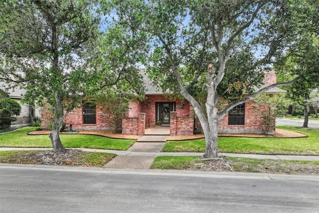 7430 Bourget Dr, Corpus Christi, TX 78413 - obstructed view of property with a front yard and brick siding