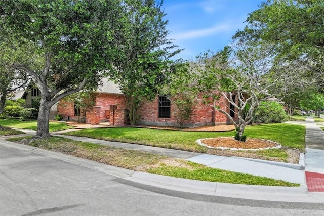 7430 Bourget Dr, Corpus Christi, TX 78413 - obstructed view of property featuring a front lawn and brick siding