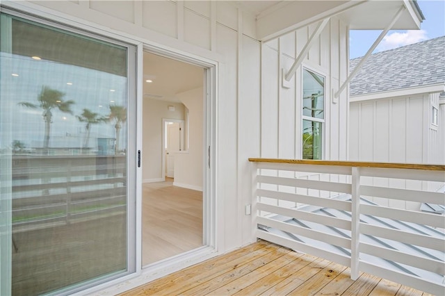 entrance to property with board and batten siding and roof with shingles