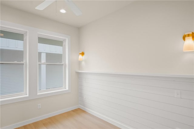 unfurnished room with light wood finished floors, ceiling fan, and baseboards