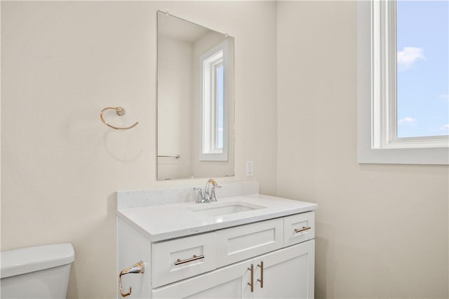 half bathroom featuring toilet and vanity