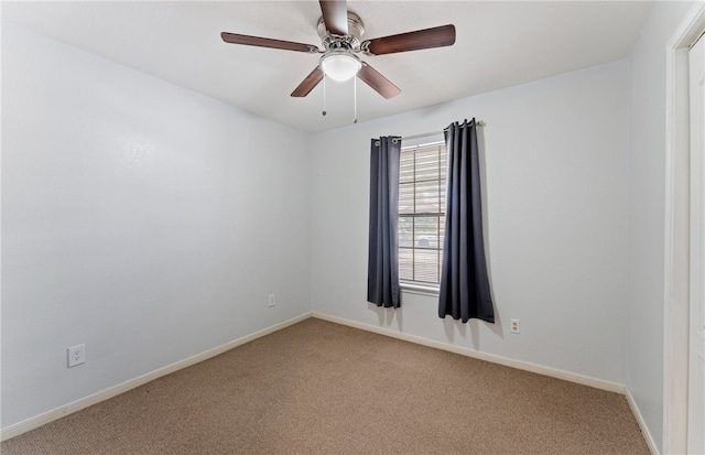 spare room featuring ceiling fan, baseboards, and carpet flooring