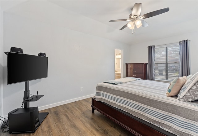 bedroom with a ceiling fan, connected bathroom, baseboards, and wood finished floors