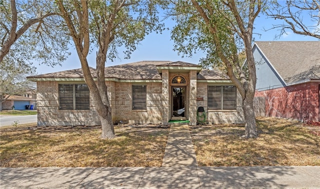 single story home with brick siding