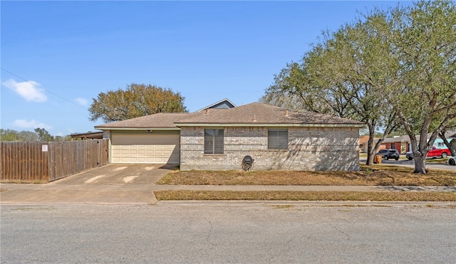 view of front of house featuring brick siding, roof with shingles, concrete driveway, an attached garage, and fence