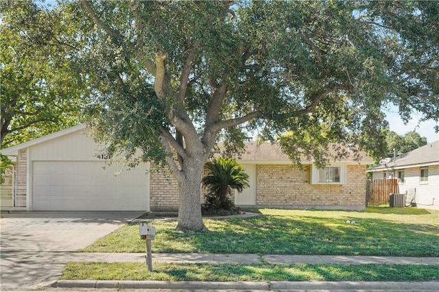 view of front facade with central AC unit, a front lawn, and a garage