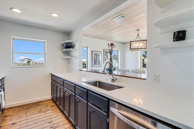 236 Dolphin Ln, Port Aransas, TX 78373 - kitchen featuring a sink, dishwasher, open shelves, light wood finished floors, and light countertops