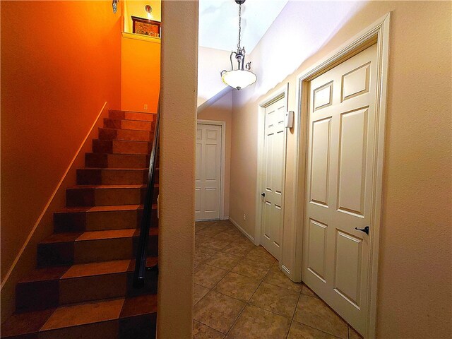 interior space featuring tile patterned flooring and vaulted ceiling