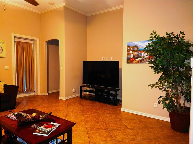 tiled living room featuring ceiling fan and ornamental molding