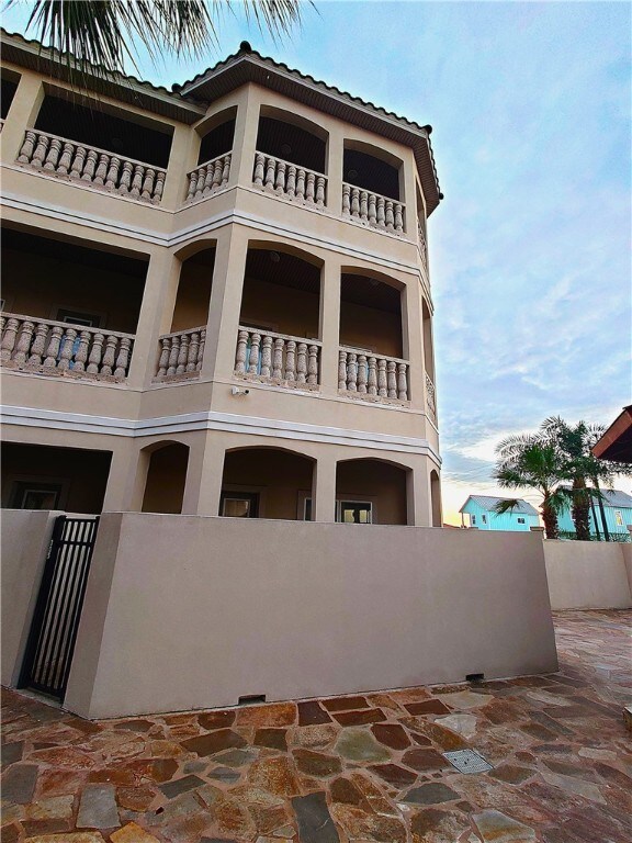 view of front of house featuring a patio and a balcony