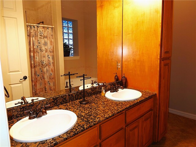 bathroom with tile patterned flooring, vanity, and curtained shower