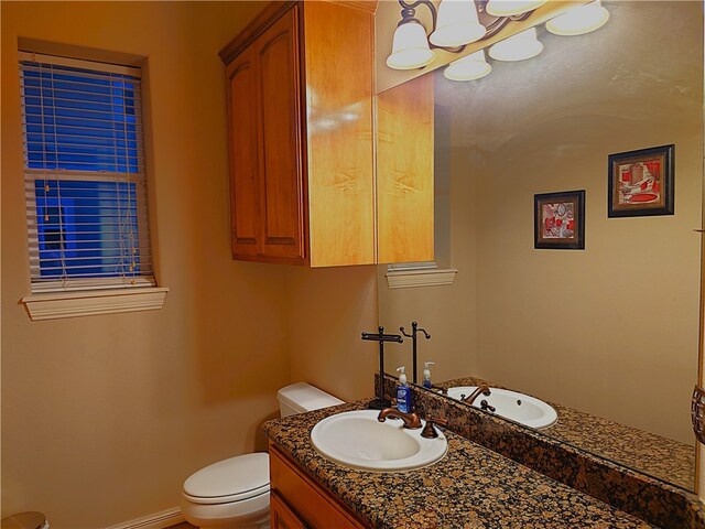 bathroom featuring toilet and vanity