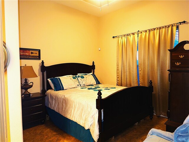 bedroom featuring dark tile patterned flooring