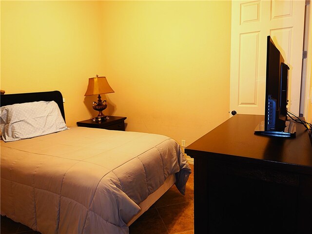 bedroom with dark tile patterned flooring