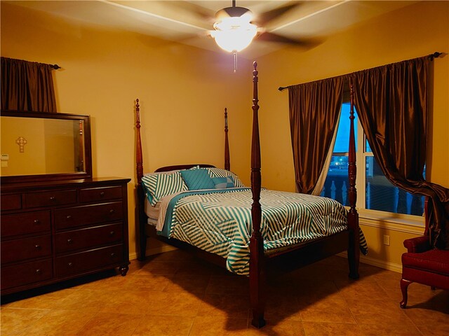 tiled bedroom featuring ceiling fan