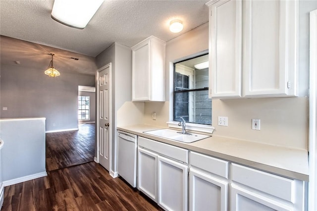 kitchen featuring dark wood-style floors, white dishwasher, a sink, and white cabinetry