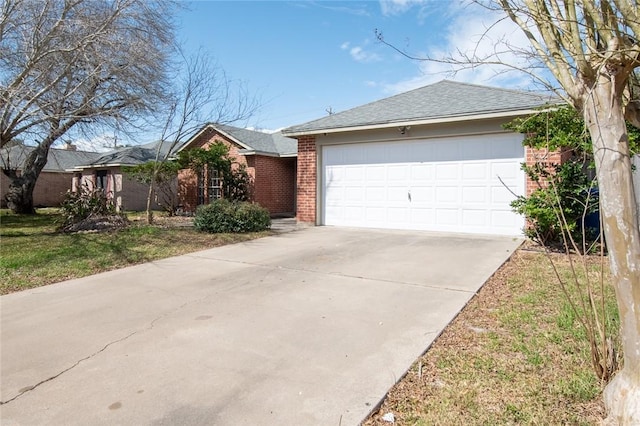 single story home with an attached garage, a shingled roof, concrete driveway, and brick siding