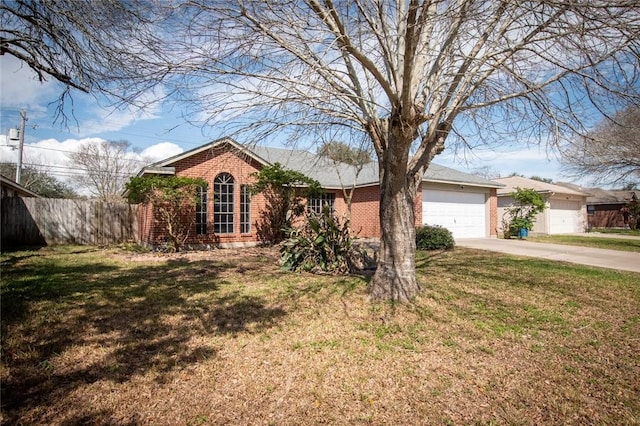 ranch-style home with brick siding, concrete driveway, an attached garage, a front yard, and fence