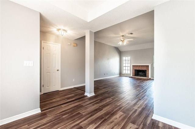 unfurnished living room with dark wood-type flooring, ceiling fan, and baseboards