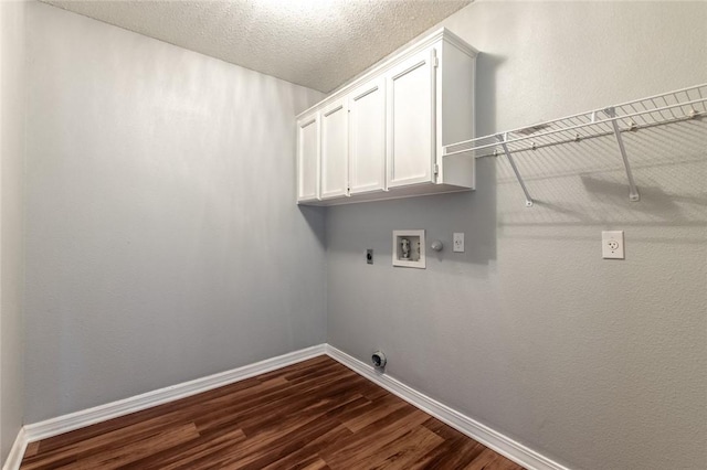 washroom with washer hookup, cabinet space, dark wood-type flooring, hookup for an electric dryer, and baseboards