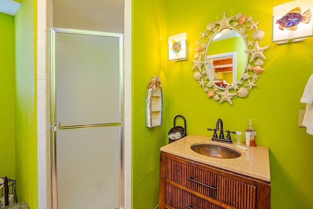 bathroom featuring a stall shower and vanity