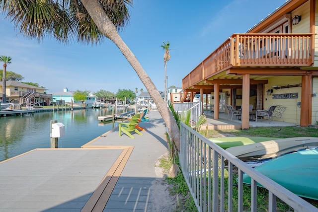 view of dock featuring a water view and a patio area