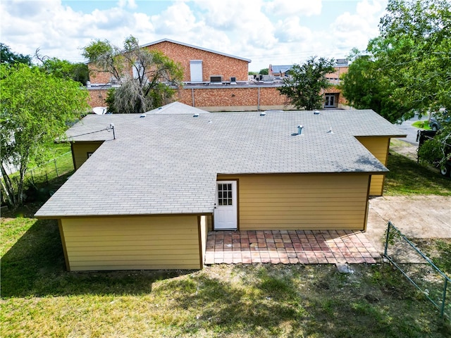 rear view of property with a lawn and a patio area