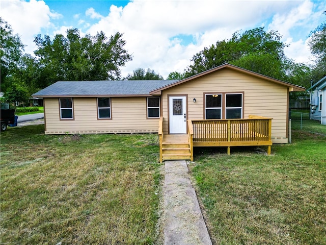 view of front of property with a front yard and a deck