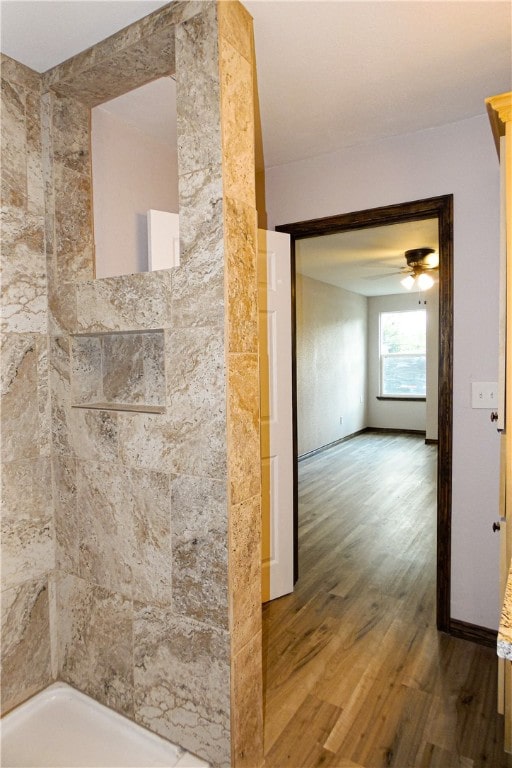 bathroom with a shower, hardwood / wood-style floors, and ceiling fan