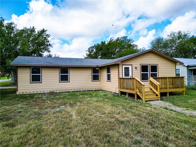 back of property featuring a lawn and a wooden deck