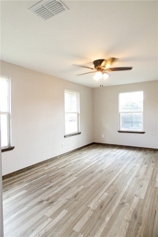 unfurnished room featuring light hardwood / wood-style flooring, a healthy amount of sunlight, and ceiling fan