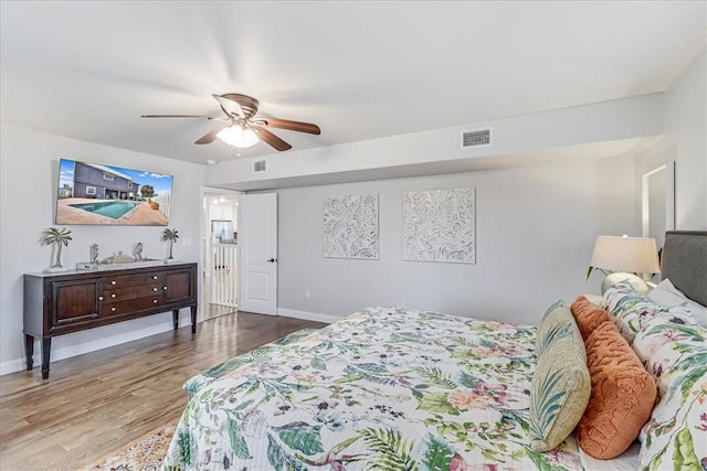 bedroom with ceiling fan and light hardwood / wood-style flooring