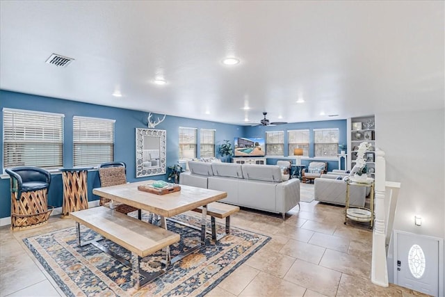 tiled dining space featuring ceiling fan