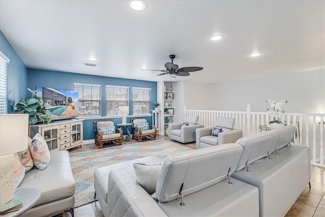 tiled living room with ceiling fan