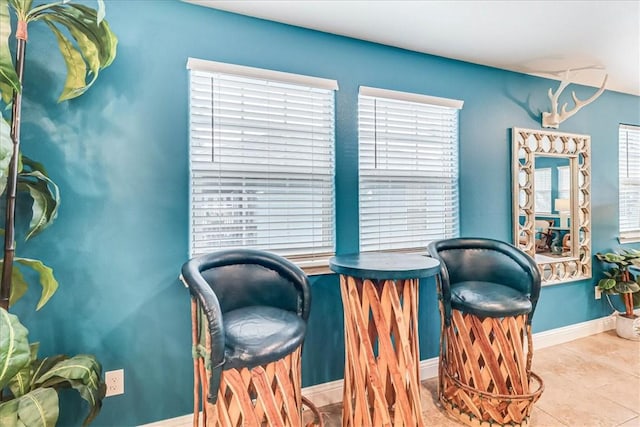 living area featuring plenty of natural light and light tile patterned flooring