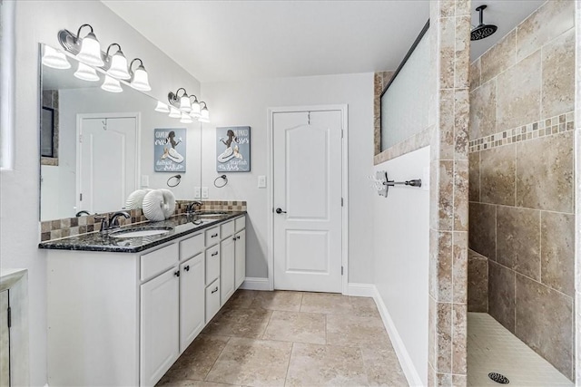 bathroom featuring a tile shower and vanity