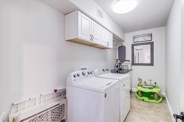 laundry room with cabinets and separate washer and dryer