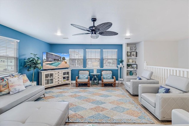 living room with hardwood / wood-style floors and ceiling fan