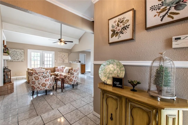 living room featuring a ceiling fan, crown molding, light tile patterned flooring, vaulted ceiling with beams, and a textured wall