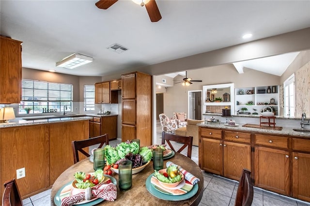 kitchen featuring brown cabinets and ceiling fan