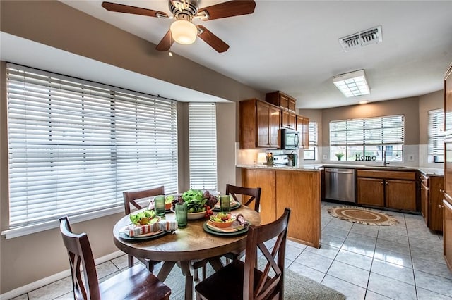 kitchen with dishwasher, visible vents, a sink, and light tile patterned floors