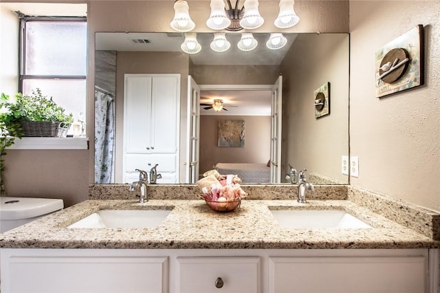 bathroom with double vanity, visible vents, and a sink