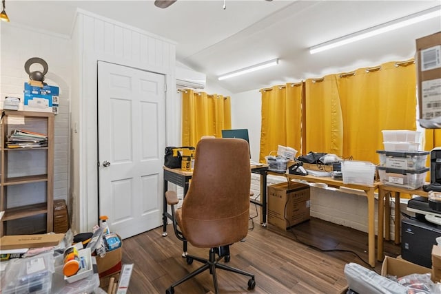 office space featuring vaulted ceiling, wood finished floors, a wall mounted air conditioner, and ceiling fan