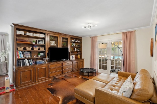 living room with dark wood-style floors, french doors, and ornamental molding