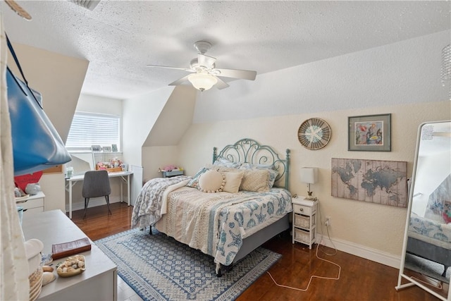 bedroom with baseboards, vaulted ceiling, wood finished floors, a textured ceiling, and a ceiling fan