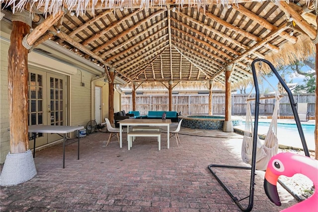 view of patio / terrace featuring an outdoor living space, a fenced in pool, french doors, and fence