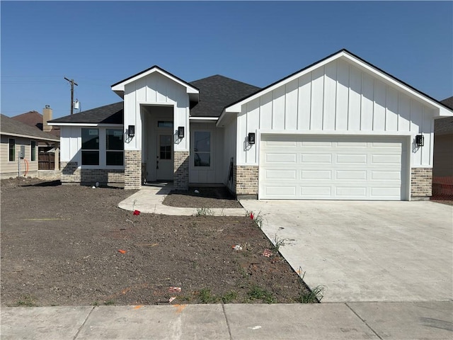 view of front of home featuring brick siding, board and batten siding, and an attached garage