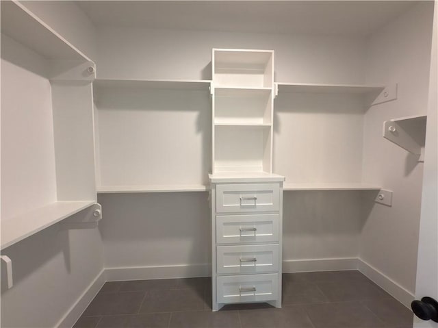 spacious closet featuring dark tile patterned floors